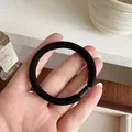 Elastic black hair tie with thick ribbed texture and smooth connector for daily use - Black
