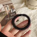 Soft black plush hair scrunchie with glossy buckle for elegant ponytail styling - Black