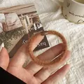 Plush faux mink hair tie in coffee brown with a glossy resin buckle closure - Brown