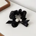 Elegant black organza scrunchie featuring white pearls and a classic satin bow accent - Black