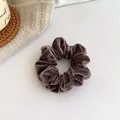 Velvet hair scrunchie in deep taupe color with soft pleats on knit background - Brown