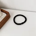 Simple black high-elasticity hair tie with a polished olive bead for minimalist hair styling - Black