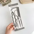 Hair styling tool set including combs and bun makers on a white brand card - 4 Piece Set (Hair Tail x2 + Comb + Braider) / Gray