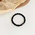 Durable black spiral hair tie with elastic woven texture and secure cylinder joint - Black
