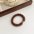 Brown high-elasticity braided hair tie with a sleek spiral texture and durable buckle - Brown