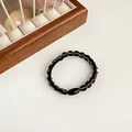 Elastic braided hair tie with black and silver metallic thread and oval buckle - Black