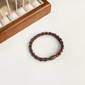 Elastic braided hair tie in coffee brown with white accents and a smooth oval buckle - Brown