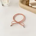 Elegant peach pink bow hair tie with double strands and gold metal cylinder accents - Orange Pink