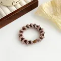 Coletero de espiral trenzado marrón y beige con núcleo elástico de alta resistencia y cierre - Marrón Café