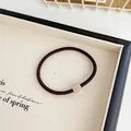 Elastic coffee hair tie with golden heart rhinestone charm in a wooden tray - Dark Coffee