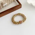 Golden khaki velvet hair scrunchie with a sparkling rhinestone ball charm detail - Khaki
