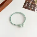 Elastic mint green hair tie with four-in-one knotted design for sleek ponytail styling - Light Green