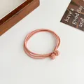 Pink peach elastic hair tie with braided double knots in a minimalist 4-in-1 design - Orange Red