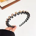 Zwarte golvende haarband met amberkleurige strass bloemen voor dames - Champagne