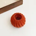Orange flocked velvet bird nest hair clip in a fully contracted expandable state - Orange Red