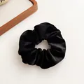 Classic black velvet scrunchie featuring premium texture for elegant hair styling - Black