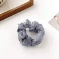 Elegant grey pearlescent organza scrunchie hair tie on a white minimalist background - Dark Gray