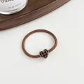 Brown high-elastic hair tie featuring a heart-shaped checkerboard pattern pendant - Brown