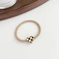 Elastic hair tie in milk coffee color with a heart-shaped checkerboard pattern charm - Khaki