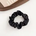 Glossy black satin scrunchie for ponytails featuring a premium pleated fabric design - Black