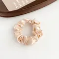Elegant champagne satin scrunchie with a soft silk sheen and minimalist design - Nude