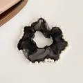 Elegant black organza scrunchie featuring decorative white pearls along the outer edge - Black