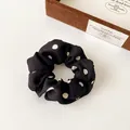 Elastic black fabric scrunchie with white polka dots design in a French retro style - Spotted Black