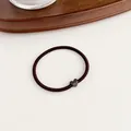 Minimalist elastic hair tie with dark brown heart charm decoration on a white surface - Dark Coffee
