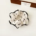White satin scrunchie with black floral patterns and contrast wave stitching - Flower