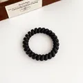 Élastique à cheveux spirale noir mat avec finition dépolie pour queues de cheval souples - Noir