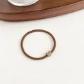 Minimalist coffee brown elastic hair tie with a matte heart-shaped decorative charm - Brown