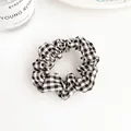 Minimalist black and white plaid scrunchie with pleated fabric texture on white background - Black