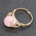 Handmade gold wire-wrapped ring featuring a round pink quartz bead and adjustable band - Rose Quartz