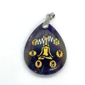 Teardrop amethyst pendant with golden meditating figure and spiritual symbols - 25x32mm / Purple Crystal