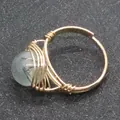 Handmade gold wire-wrapped ring featuring a round rutilated quartz bead in a minimalist style - Rutilated Quartz Style (No. 3)