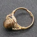 Handmade wire wrapped ring with a large brown spherical gemstone in golden finish - Tiger's Eye