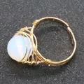 Handmade gold wire-wrapped ring featuring a polished milky white round gemstone bead - Opal