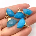 Vibrant royal blue faceted stone pendant with gold metal clasp held in palm - Sapphire Blue