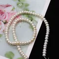 Macro-opname van hoogwaardige witte zoetwaterparels met natuurlijke glans voor sieraden - Platte kraal / 4-5mm