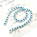 Macro detail of star-shaped natural mother of pearl beads with blue evil eye pattern - 8mm Style / White