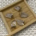 Five pieces of horn-shaped crystal pendants with gold edges on a bamboo tray - Transparent Crystal