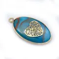 Detailed view of oval blue stone pendant with golden heart filigree and metal frame - Hollow Heart Style (1)