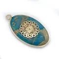 Detail of blue natural stone oval pendant with golden filigree mandala inlay and metallic rim - Mandala Floral Pattern (4)