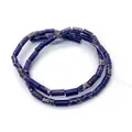 Macro view of cylindrical purple imperial stone beads with marble texture for jewelry - Deep purple