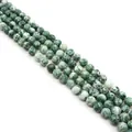 Macro view of natural green spotted round stone beads for DIY jewelry making - 4mm