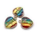 Macro shot of three heart-shaped striped stone pendants with golden metal edges - Multicolor Striped Style