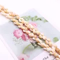 Macro shot of natural shell beads for DIY jewelry with white and creamy tones - Light Yellow Style / Medium Size