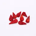 Detailed view of red carved synthetic coral teardrop beads with daisy floral patterns - Carved Floral (12x22mm) / Red (Teardrop)