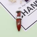 Bullet-shaped natural stone pendant with silver frame and red crystal inlay detail - Rainbow Stone