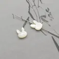 Macro view of rabbit-shaped mother of pearl beads for DIY jewelry and necklaces - Vertical Hole Rabbit Head / White